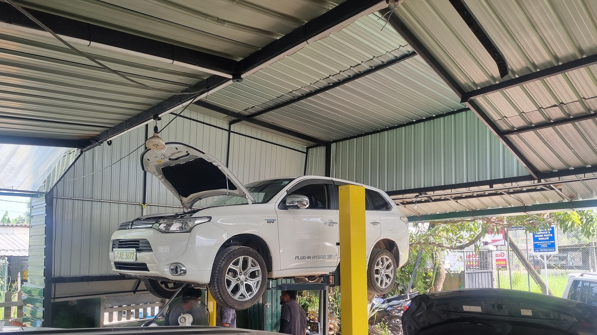Vehicle being serviced inside Green Hybrid Care workshop